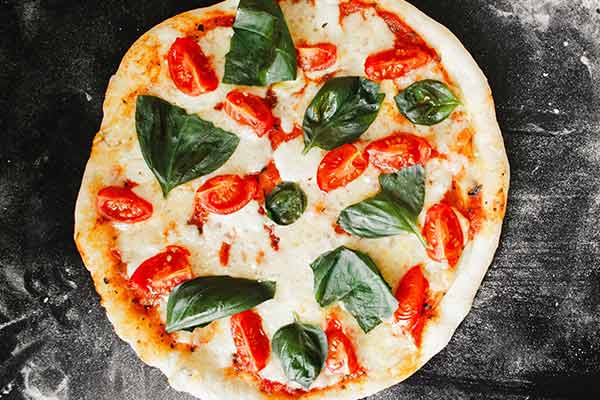 Photo of a tomato and cheese pizza